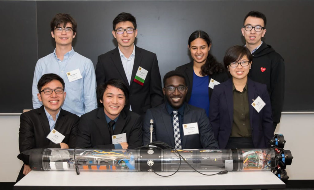 Clinic team poses with underwater device.