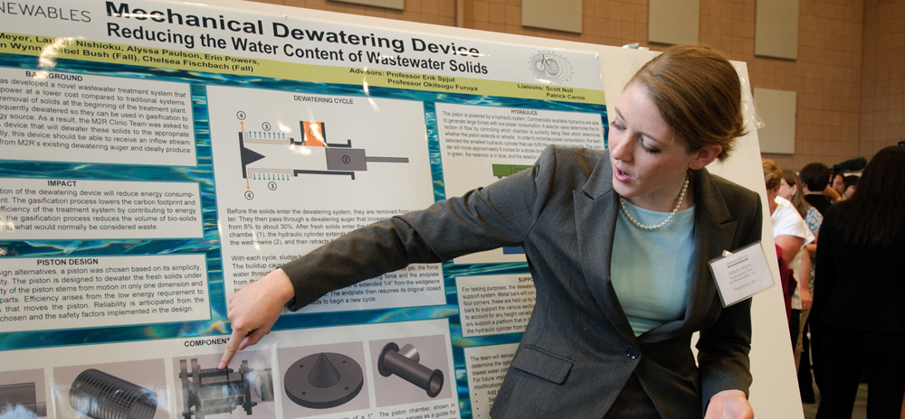 student with clinic poster