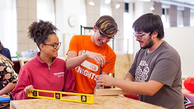 Students working together on a wooden project.