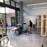 Workers build portable walls in Sprague Gallery, Harvey Mudd College