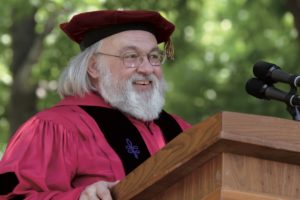 Olson in robes at lectern