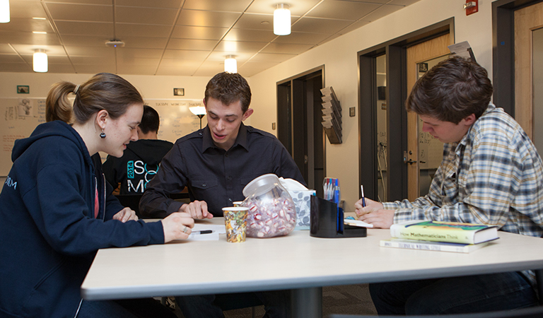 Students at a table in the Writing Center.