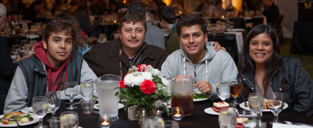 Family enjoying a meal together at Family Weekend.