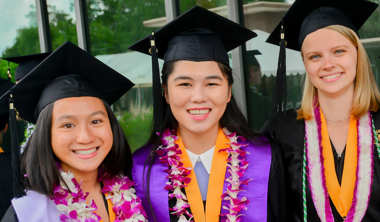 Three graduates in robes