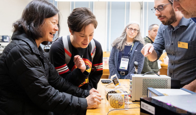 Families watch experiment on bench