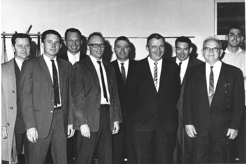 Nine men in suits