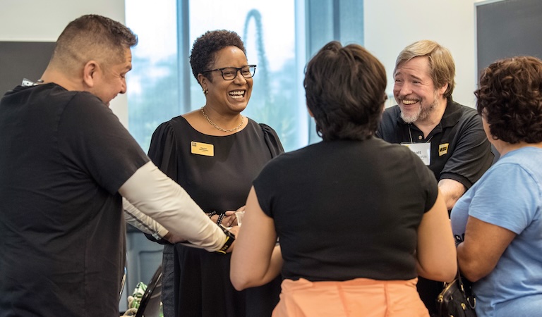 Harriet Nembhard talking with four people