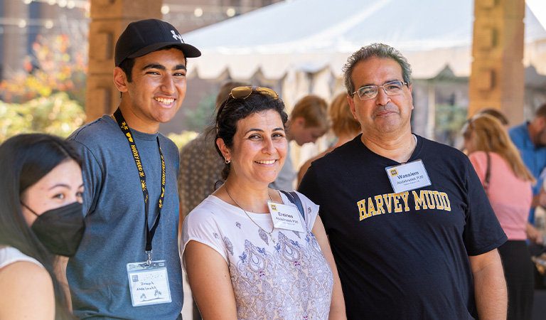 Harvey Mudd student standing with parents.