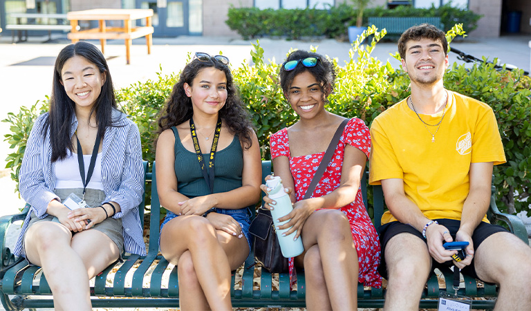 Harvey Mudd Students sitting on a bench.