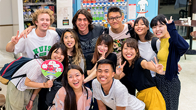 Students gather with locals in a Japanese store.