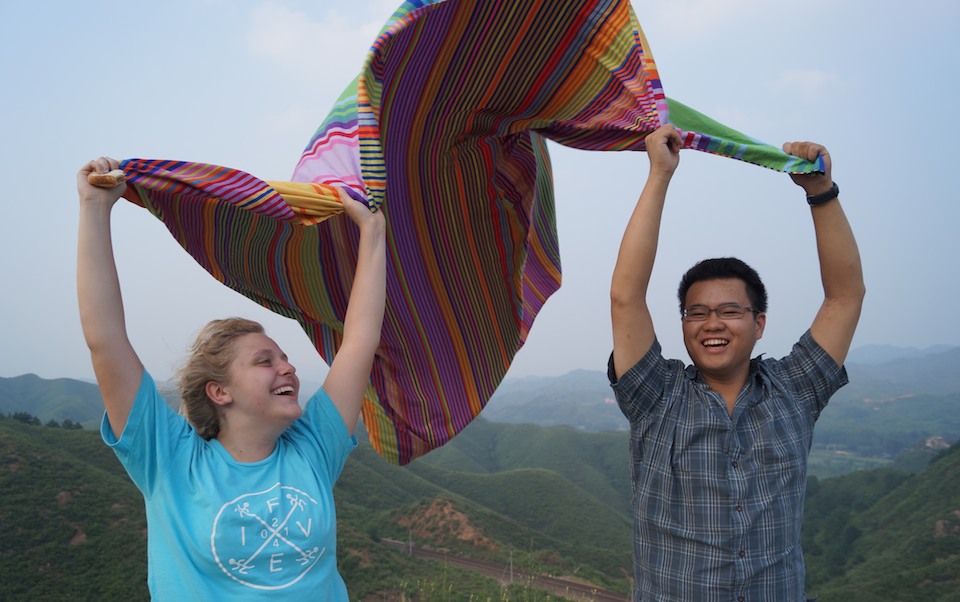 Students wave a colorful blanket on the Great Wall of China