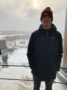 Ethan Sargent in front of a snowy Moscow cityscape.