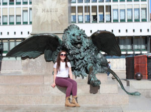 Marianna Sbordone in front of winged lion statue.