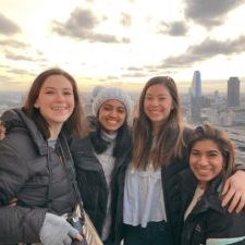 Vicki Moran and three friends in front of city skyline