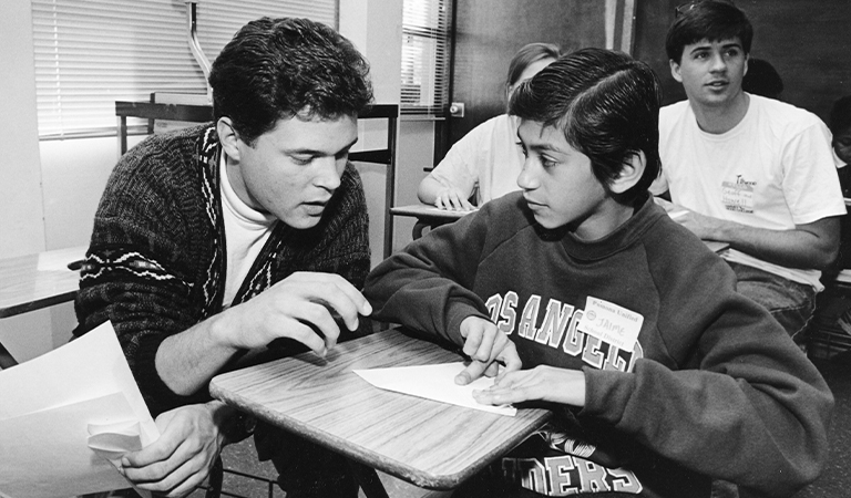 Teacher speaking with a student.